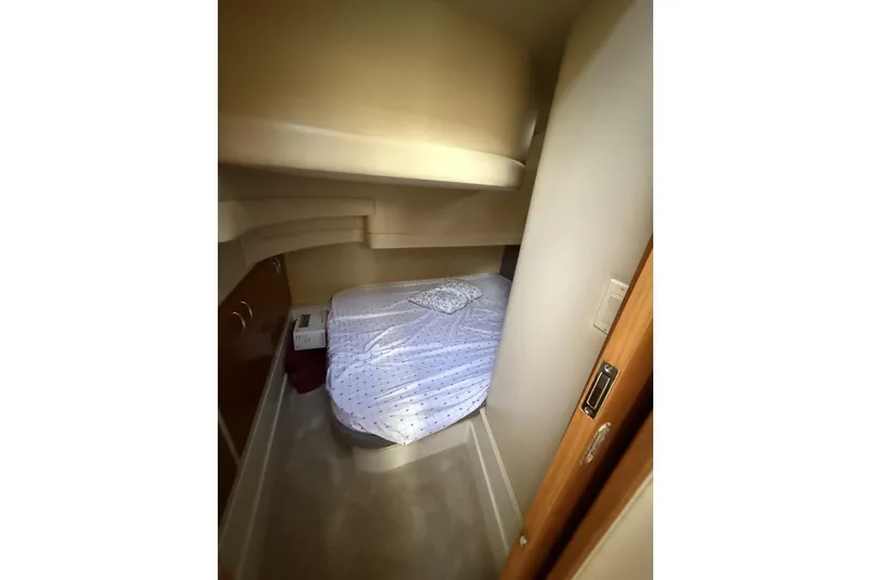 Slide: The Image of Cozy bedroom in 2006 Carver 38 Super Sport yacht with a neatly made bed. - 17