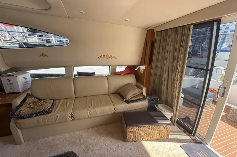 Slide: The Image of Interior of 2006 Carver 38 Super Sport yacht with beige sofa and large windows. - 18