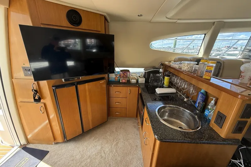 Slide: The Image of Interior of 2006 Carver 38 Super Sport yacht with kitchenette and TV. - 19