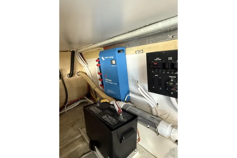 Slide: The Image of Electrical system inside 2006 Carver 38 Super Sport boat, featuring Victron Energy charger. - 23