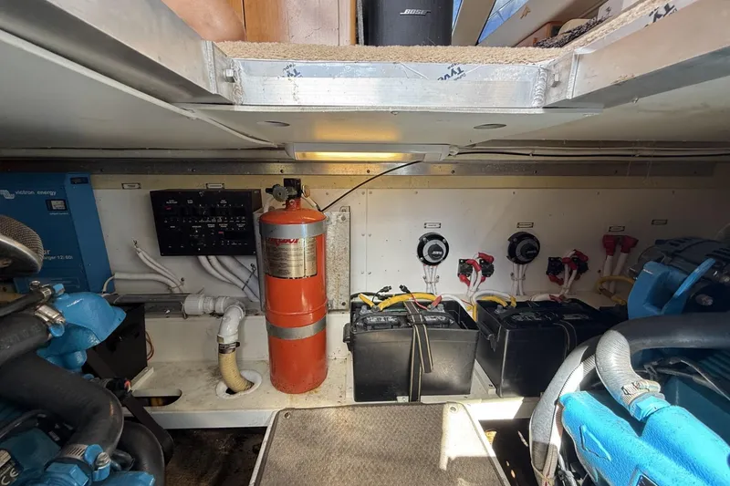 Slide: The Image of Engine room of a 2006 Carver 38 Super Sport with batteries and fire extinguisher. - 24