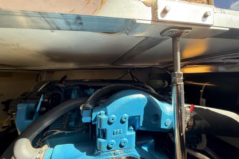 Slide: The Image of Engine compartment of a 2006 Carver 38 Super Sport boat, featuring blue machinery. - 25