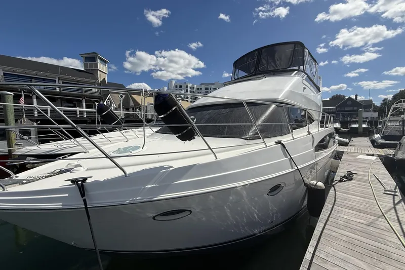 Slide: The Image of 2006 Carver 38 Super Sport yacht docked at marina under blue sky. - 3