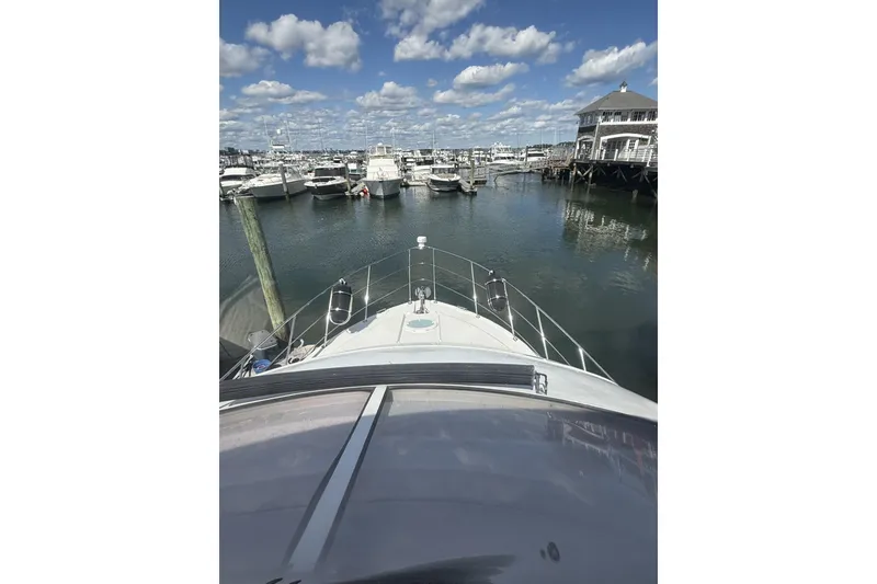 Slide: The Image of 2006 Carver 38 Super Sport yacht docked in a marina under a blue sky. - 5