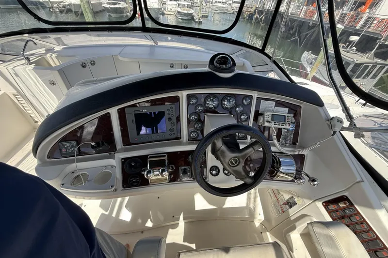Slide: The Image of 2006 Carver 38 Super Sport helm with navigation instruments and steering wheel at marina. - 7