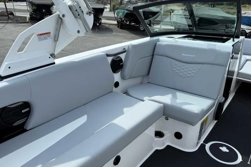 Slide: The Image of 2026 MasterCraft NXT22 boat interior with gray seating and modern design. - 10