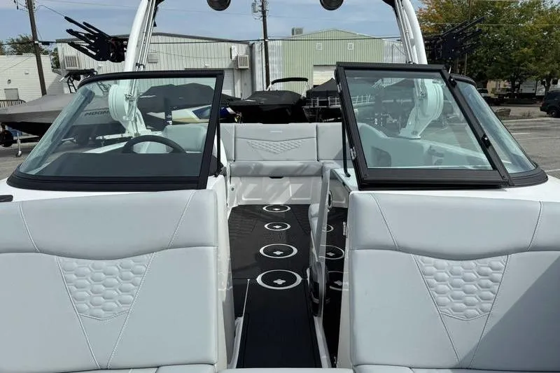 Slide: The Image of 2026 MasterCraft NXT22 boat interior with open windshield and modern seating design. - 12