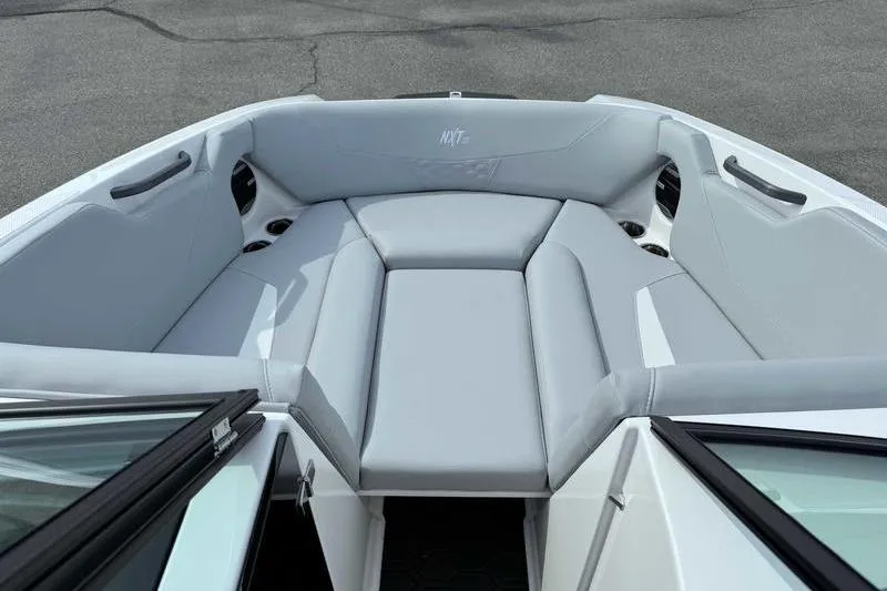 Slide: The Image of 2026 MasterCraft NXT22 boat interior with gray seating and cup holders. - 13