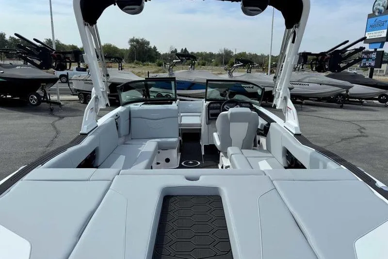 Slide: The Image of 2026 MasterCraft NXT22 boat interior with sleek seating and modern dashboard. - 6