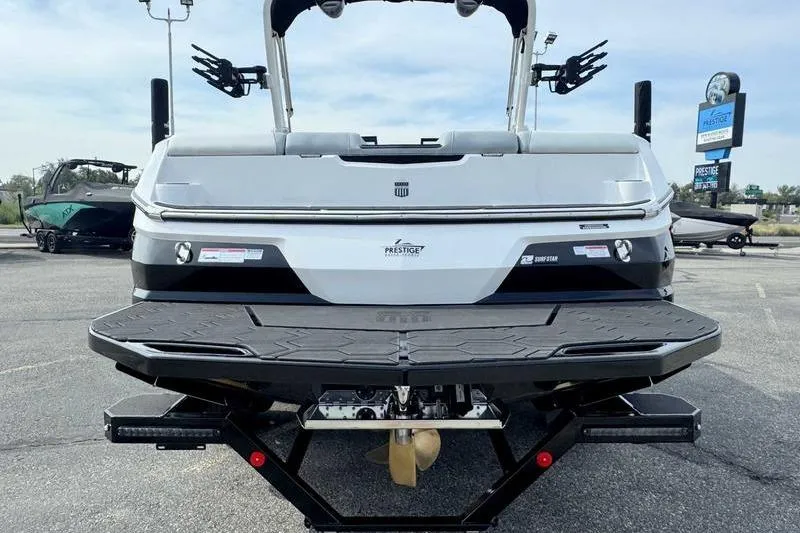 Slide: The Image of 2026 MasterCraft NXT22 boat rear view with swim platform and propeller. - 8