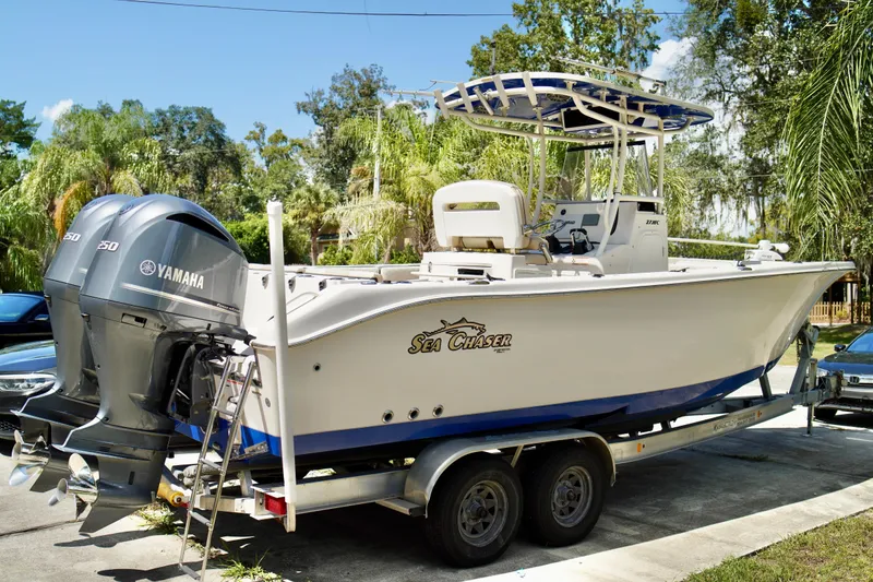 The Image of 2019 Carolina Skiff Sea Chaser 27 HFC boat on trailer with Yamaha engines. - 0