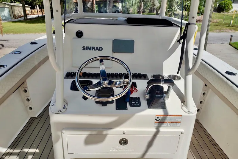 Slide: The Image of 2019 Carolina Skiff Sea Chaser 27 HFC helm with Simrad electronics and steering wheel. - 15