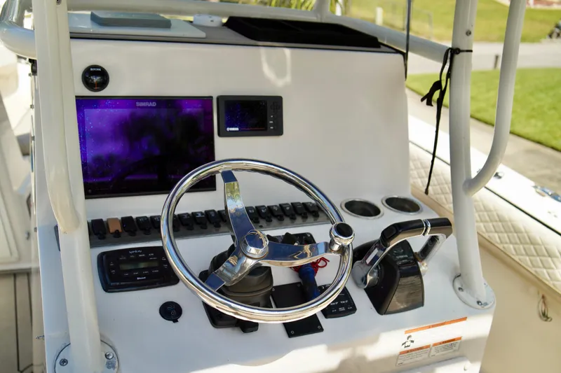Slide: The Image of Control panel of 2019 Carolina Skiff Sea Chaser 27 HFC boat with steering wheel and electronics. - 16