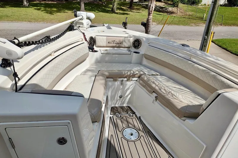 Slide: The Image of 2019 Carolina Skiff Sea Chaser 27 HFC boat interior with cushioned seating and deck. - 6