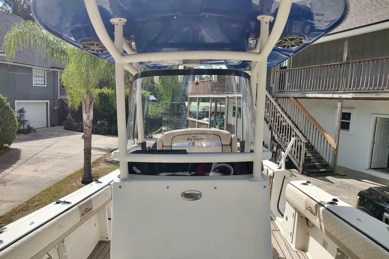 Slide: The Image of 2019 Carolina Skiff Sea Chaser 27 HFC boat docked near residential area. - 9