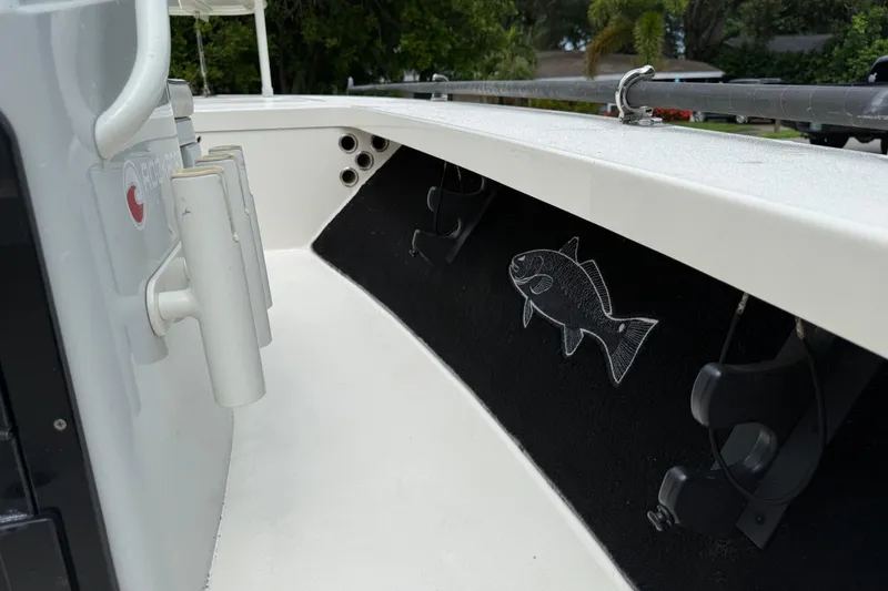 Slide: The Image of 2021 Maverick 17 HPX-S boat interior with rod holders and fish emblem. - 13