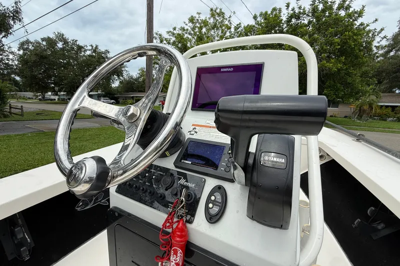 Slide: The Image of 2021 Maverick 17 HPX-S boat console with steering wheel and Yamaha controls. - 19