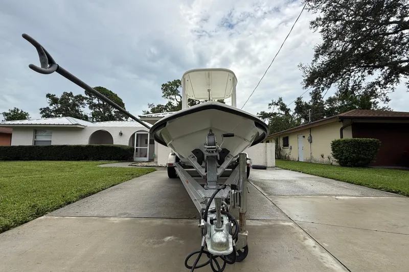 Slide: The Image of 2021 Maverick 17 HPX-S boat on trailer in residential driveway, overcast sky. - 23