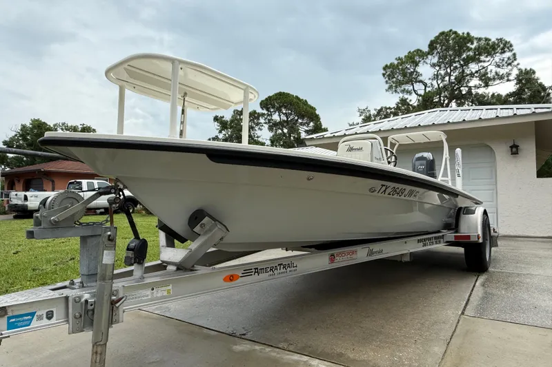 Slide: The Image of 2021 Maverick 17 HPX-S boat on trailer, parked in driveway, overcast sky. - 6
