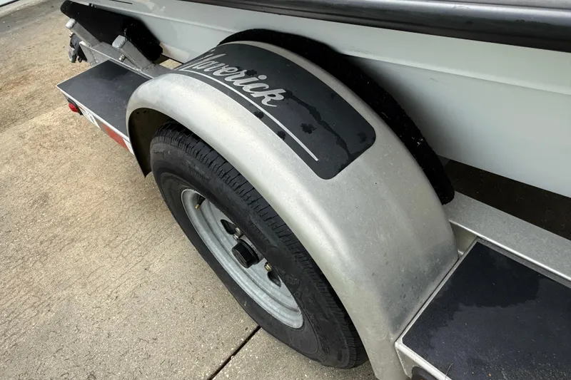 Slide: The Image of Trailer wheel of 2021 Maverick 17 HPX-S boat on concrete surface. - 8