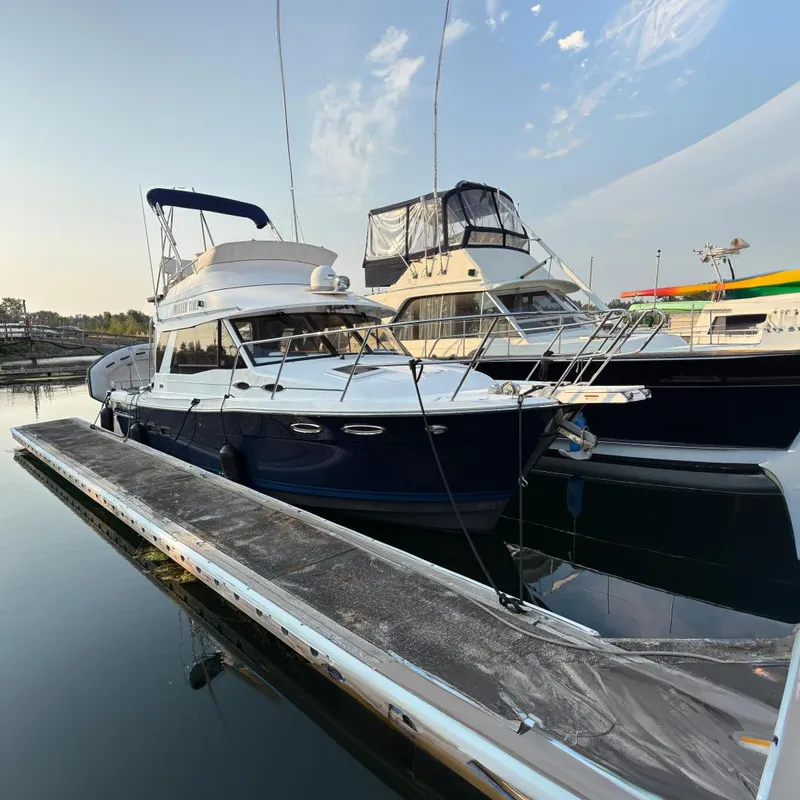 The Image of 2018 Cutwater C-30 CB boat docked at marina, featuring sleek design and modern amenities. - 0
