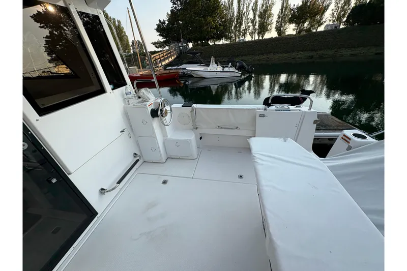 Slide: The Image of 2018 Cutwater C-30 CB boat deck with seating, docked near calm water. - 13