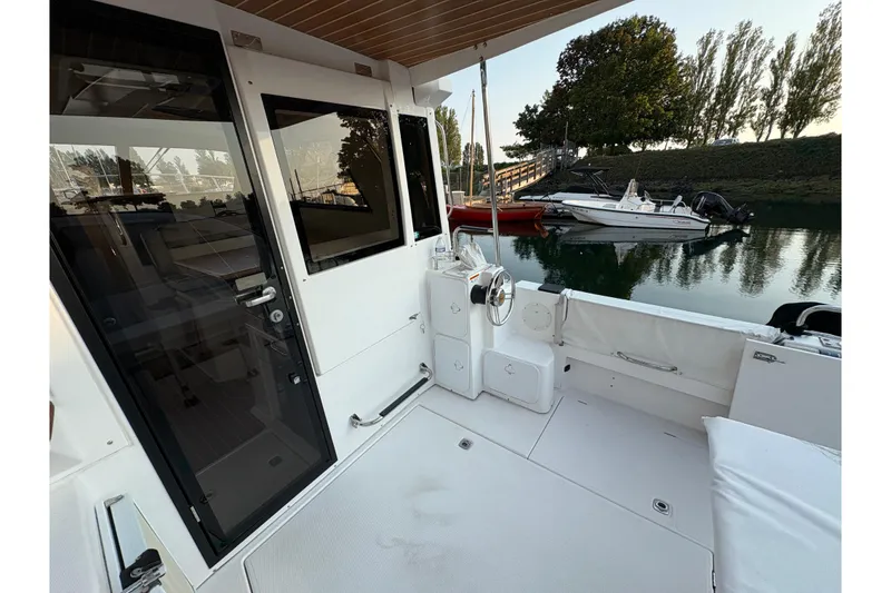 Slide: The Image of 2018 Cutwater C-30 CB boat deck with seating, docked near other boats. - 14