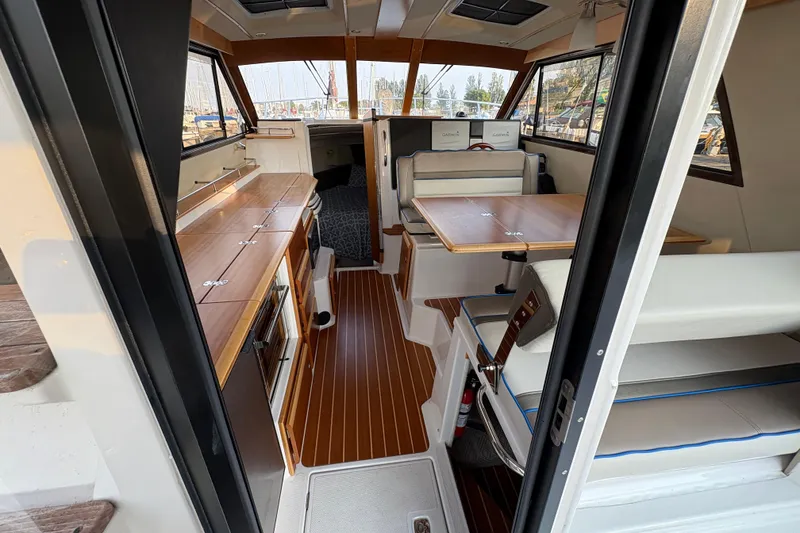 Slide: The Image of Interior of 2018 Cutwater C-30 CB boat with wood accents and seating area. - 18