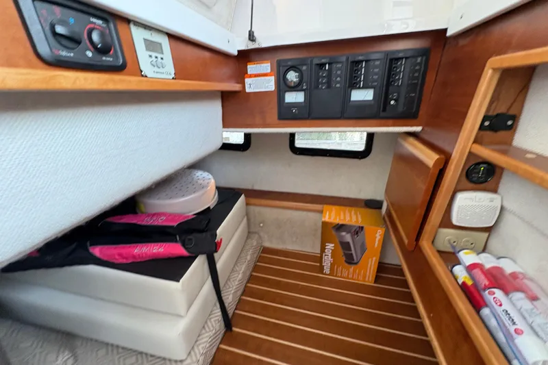 Slide: The Image of 2018 Cutwater C-30 CB cabin interior with control panels and storage shelves. - 22