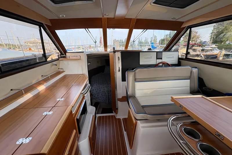 Slide: The Image of Interior of 2018 Cutwater C-30 CB boat with wood finishes and seating area. - 25