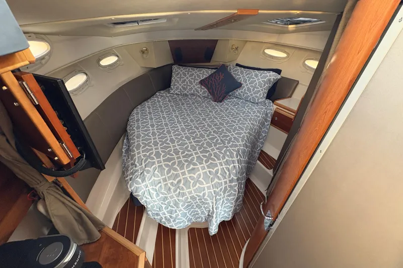 Slide: The Image of Cozy cabin interior of 2018 Cutwater C-30 CB with bed and porthole windows. - 31