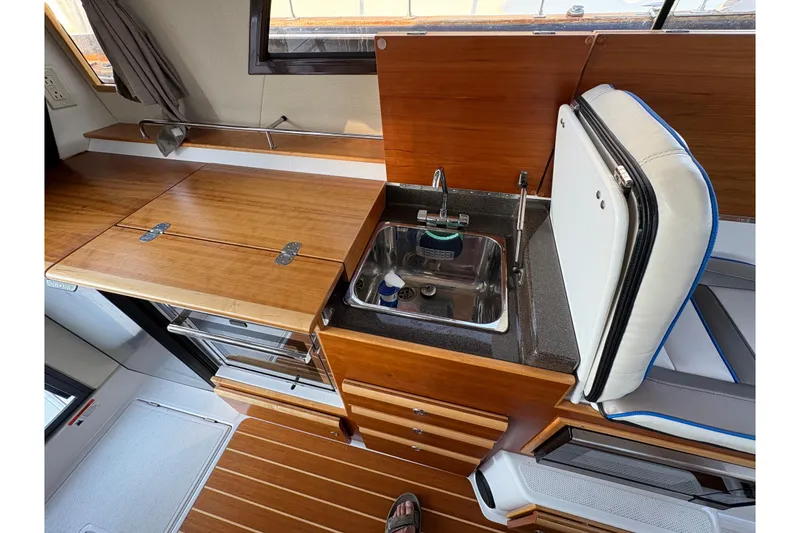 Slide: The Image of 2018 Cutwater C-30 CB boat interior with wooden cabinetry and compact kitchen sink. - 40