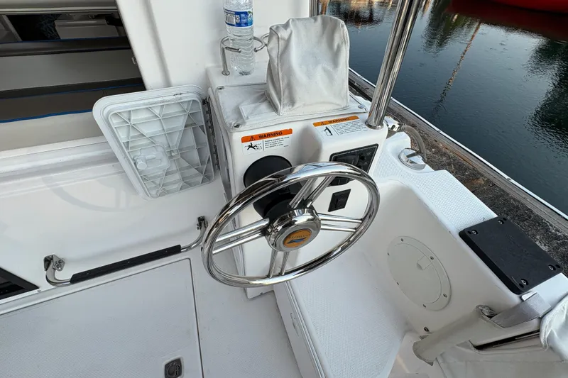 Slide: The Image of 2018 Cutwater C-30 CB boat helm with steering wheel and controls by the water. - 47