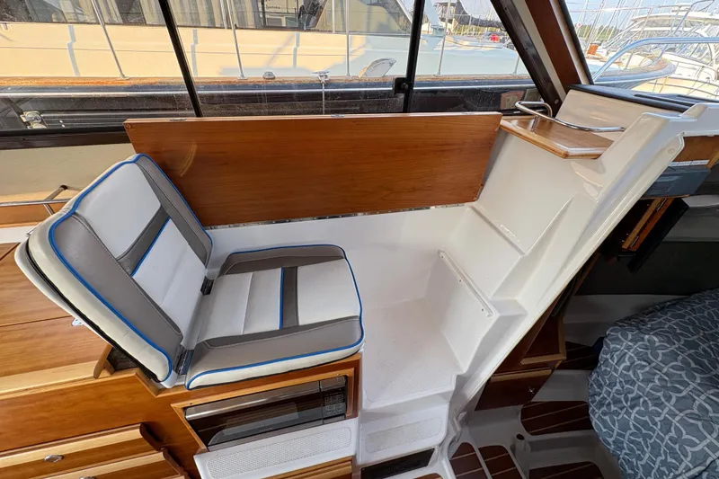 Slide: The Image of 2018 Cutwater C-30 CB interior with seating and stairs, featuring wood and white accents. - 51