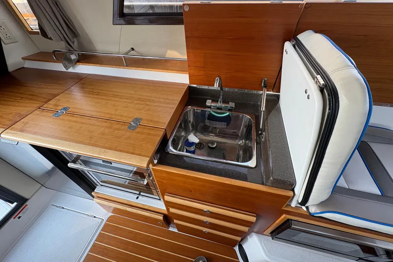 Slide: The Image of 2018 Cutwater C-30 CB boat interior with wooden cabinetry and compact sink area. - 52