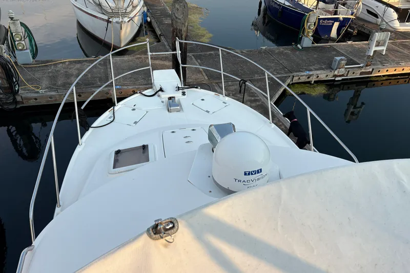 Slide: The Image of 2018 Cutwater C-30 CB boat docked at marina, featuring TracVision satellite system. - 58