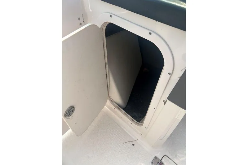 Slide: The Image of Open storage compartment on 2015 Chaparral Vortex 203 VR boat. - 15