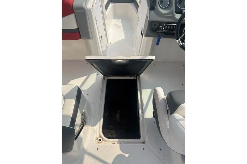 Slide: The Image of 2015 Chaparral Vortex 203 VR boat interior with open storage compartment. - 23