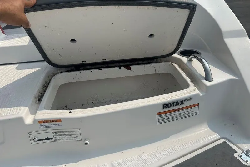 Slide: The Image of Open storage compartment on 2015 Chaparral Vortex 203 VR boat. - 24