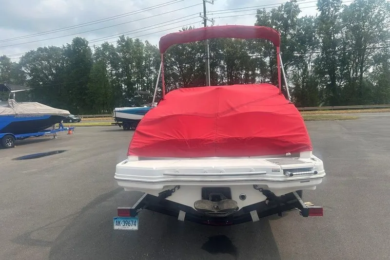 Slide: The Image of 2015 Chaparral Vortex 203 VR boat with red cover, parked outdoors. - 26