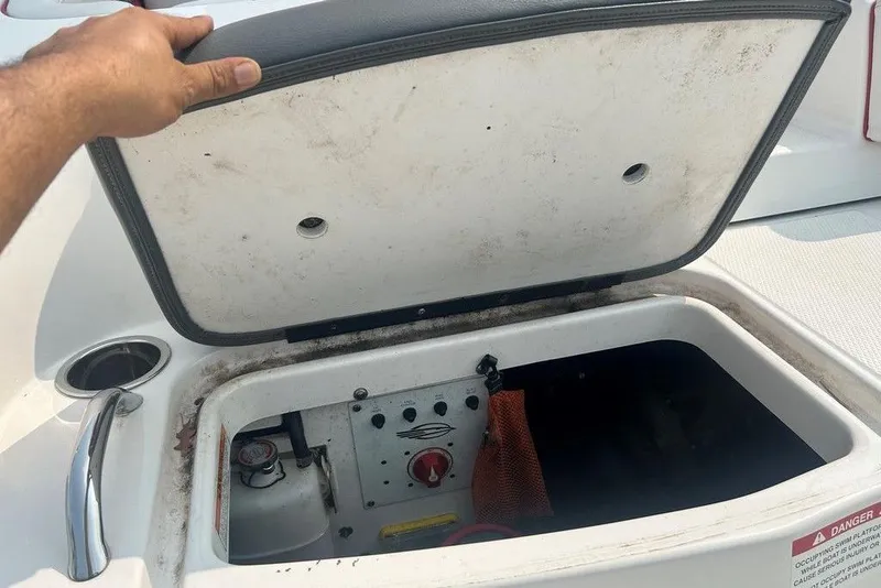Slide: The Image of Open storage compartment on 2015 Chaparral Vortex 203 VR boat, showing interior details. - 28