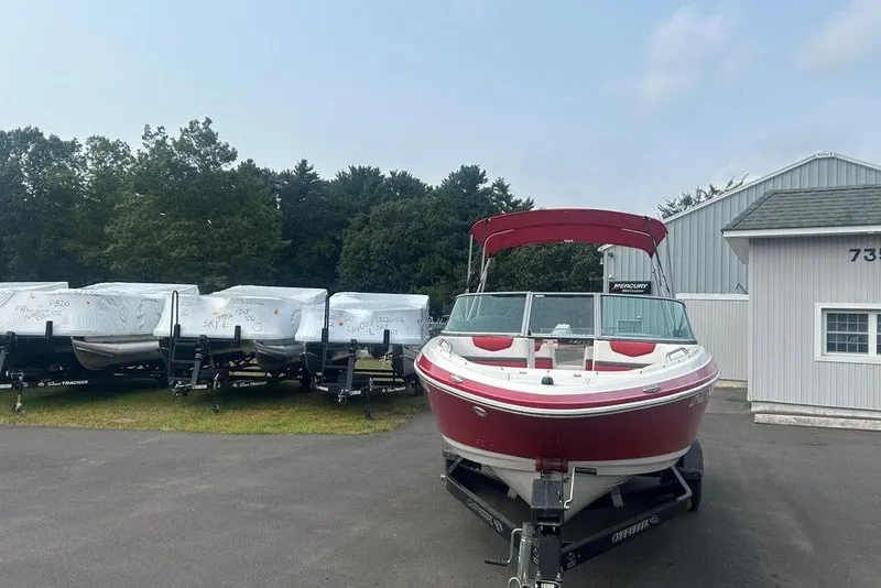 Slide: The Image of 2015 Chaparral Vortex 203 VR boat on trailer, parked near storage facility. - 3