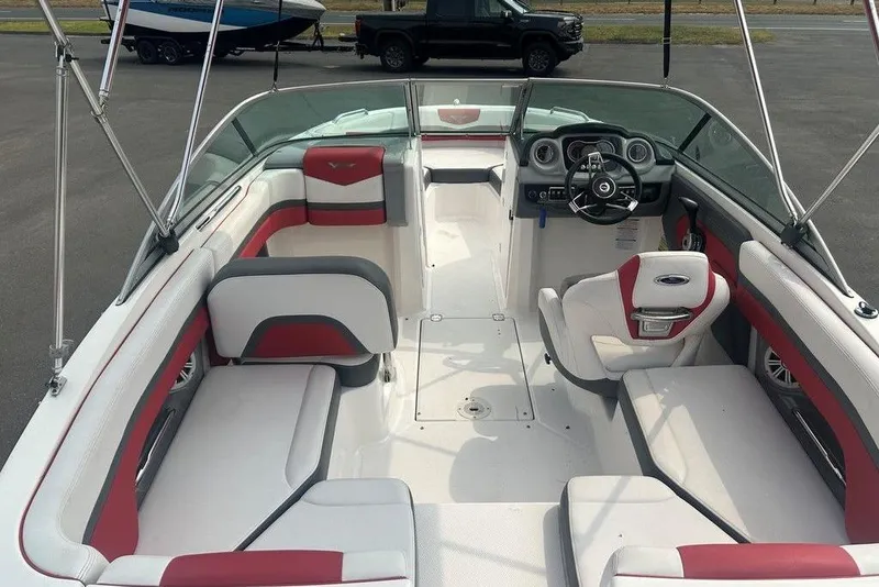 Slide: The Image of 2015 Chaparral Vortex 203 VR boat interior with red and white seating, steering wheel, and dashboard. - 7