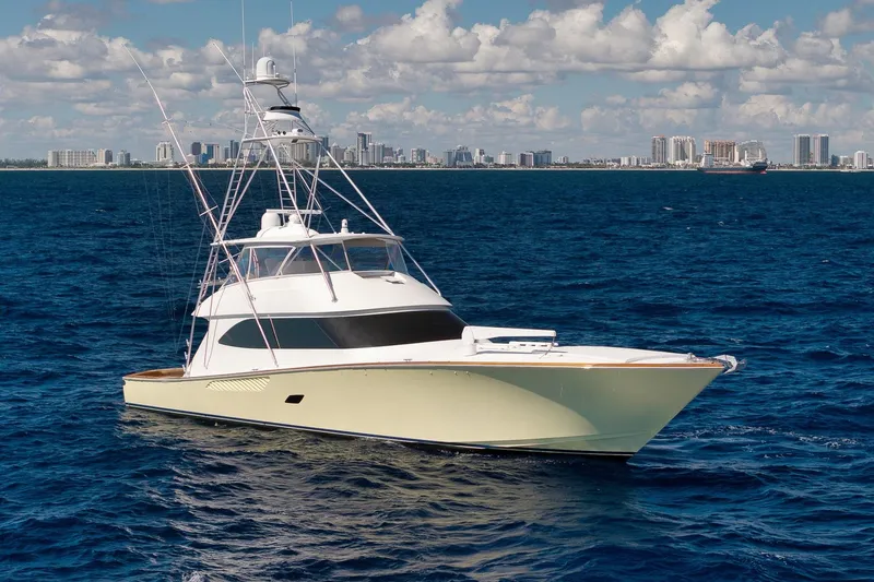 Slide: The Image of 2010 Viking 82 Convertible yacht on open sea with city skyline in background. - 10