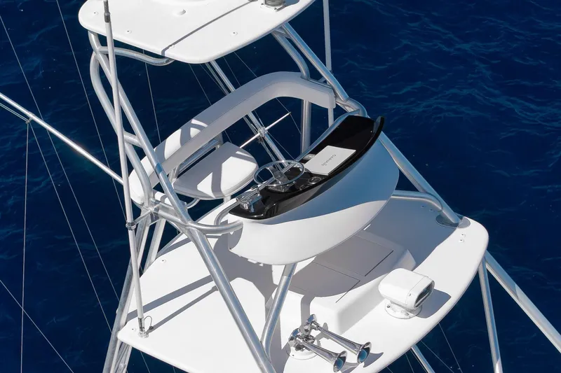 Slide: The Image of Viking 82 Convertible 2010 yacht tower with steering controls over deep blue sea. - 11