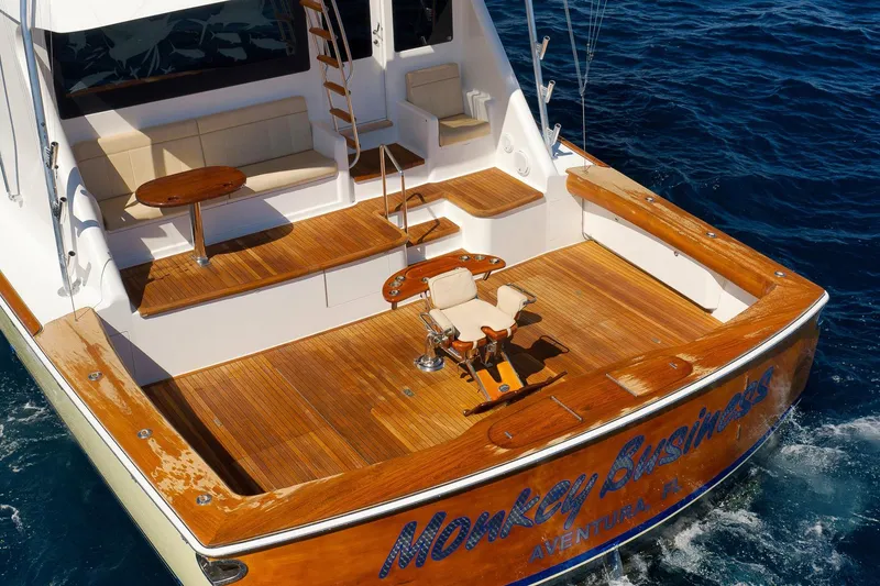 Slide: The Image of 2010 Viking 82 Convertible yacht with teak deck and fishing chair on open sea. - 12
