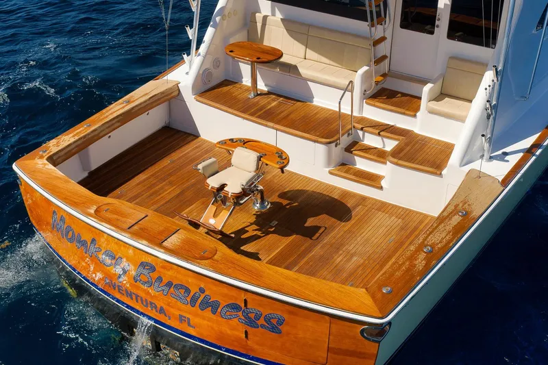 Slide: The Image of 2010 Viking 82 Convertible yacht with teak deck, fishing chair, and seating area. - 13