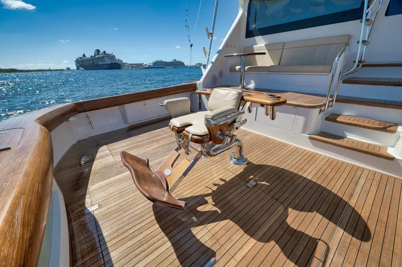 Slide: The Image of Luxurious 2010 Viking 82 Convertible yacht deck with fishing chair, overlooking ocean and cruise ships. - 16