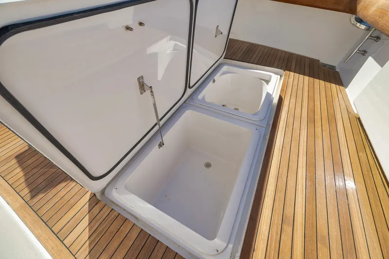 Slide: The Image of Open storage compartments on 2010 Viking 82 Convertible yacht with teak flooring. - 20