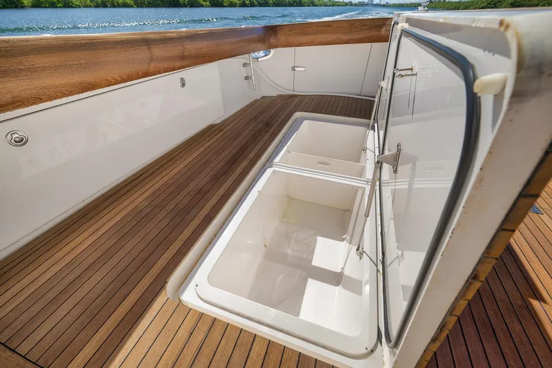 Slide: The Image of Open storage compartment on 2010 Viking 82 Convertible yacht with wooden deck. - 21